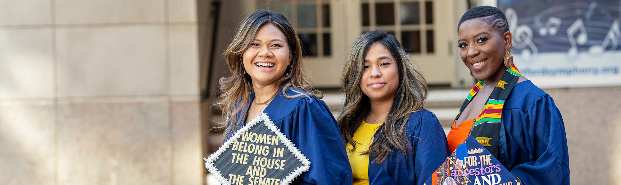 3 female students in graduation caps and gowns