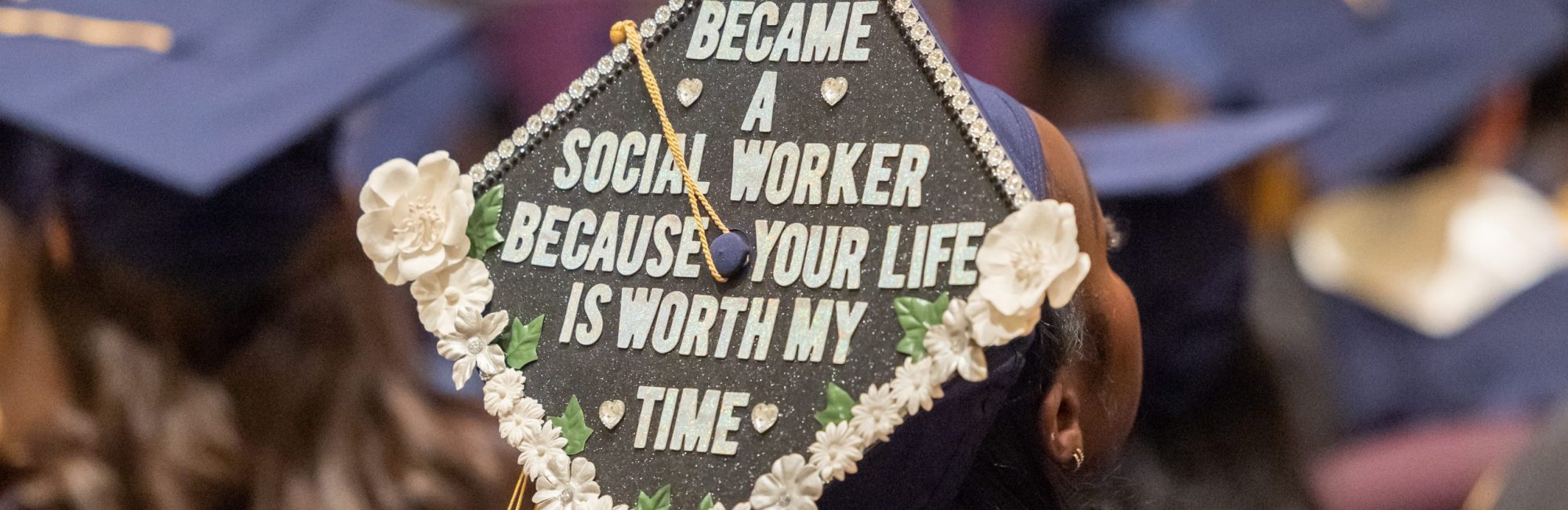 Image of mortarboard worn by student at the 2023 School of Social Work Commencement ceremony with words, "I became a social worker because your life is worth my time."